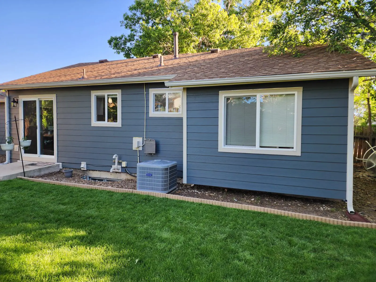 Rear elevation — Hardie lap siding, ColorPlus factory finish, new windows.