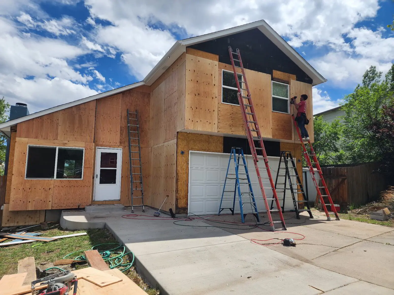 Two-story re-side — Sheathing replaced and wrapped before new siding. Colorado Springs.