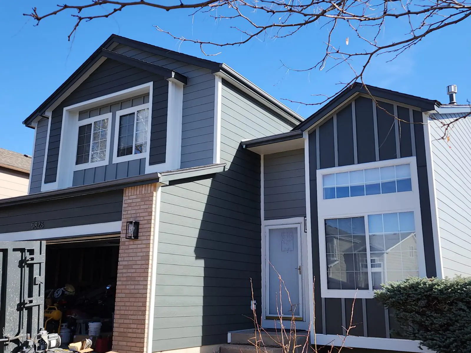 Board and batten — Hardie board-and-batten with new trim and gutters.